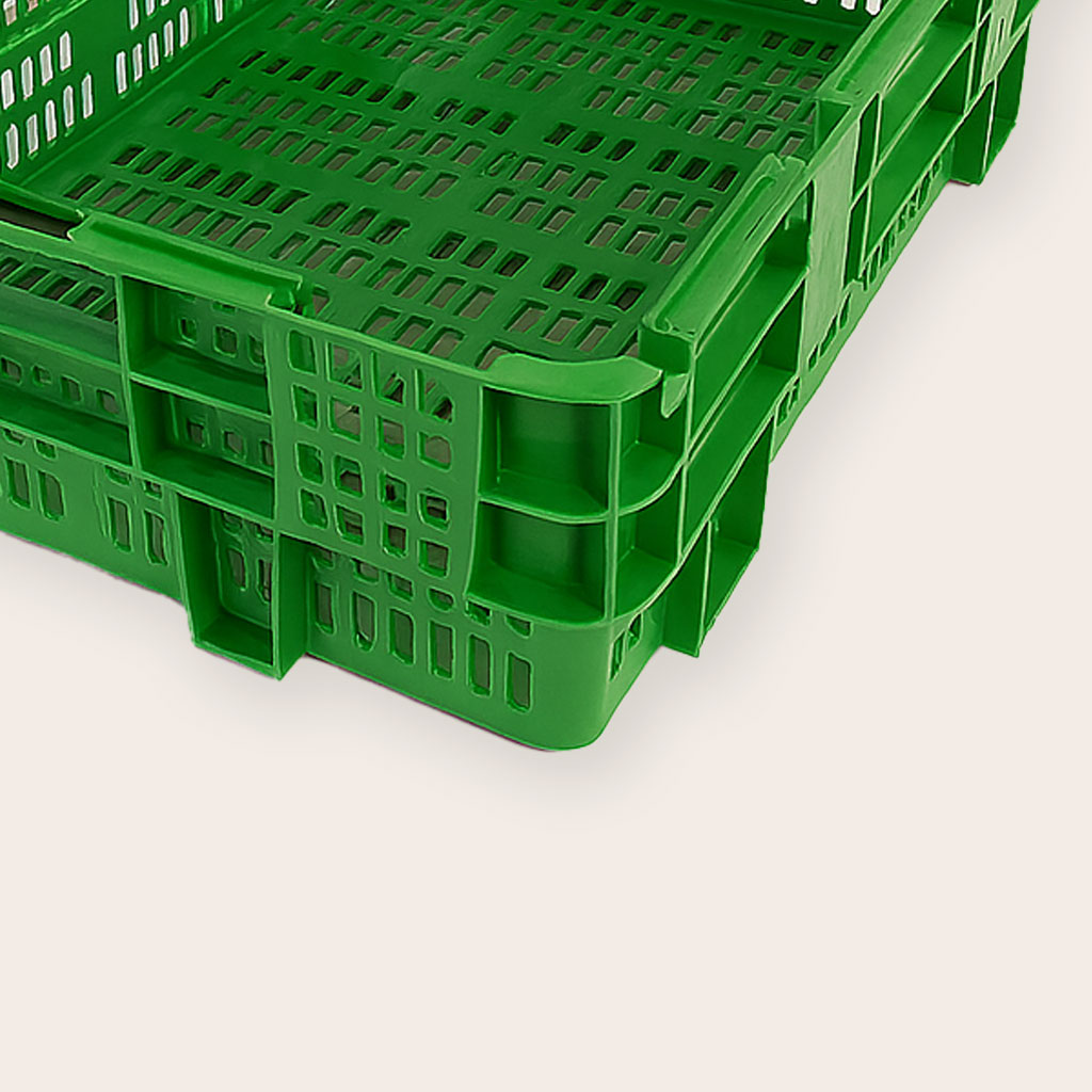 Un primer plano de la caja de plástico apilable mostrando sus perforaciones, ideales para la ventilación de productos frescos. 20149-detalle